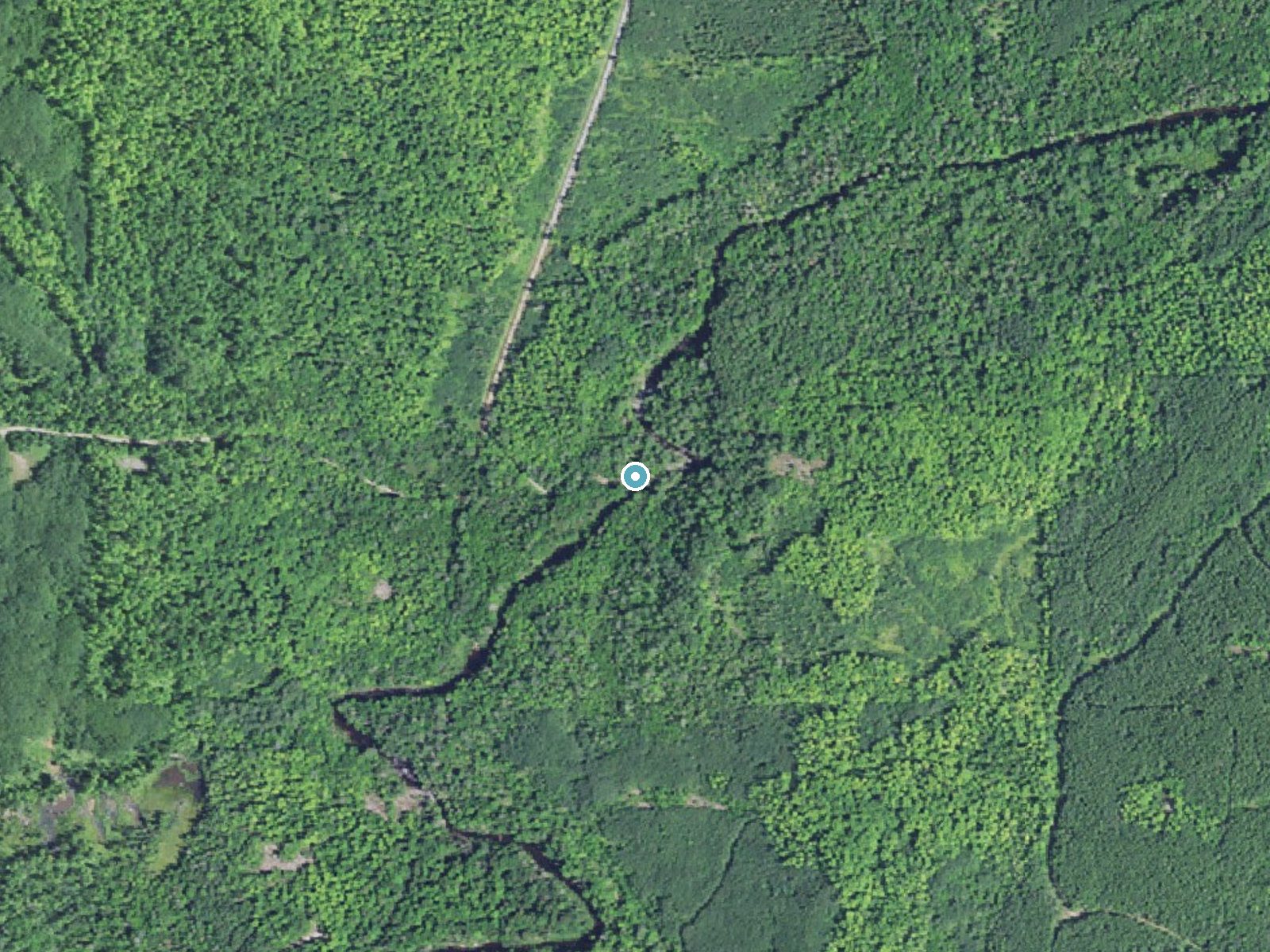 Aerial view of the ground around Silver Falls near Zeba, Michigan